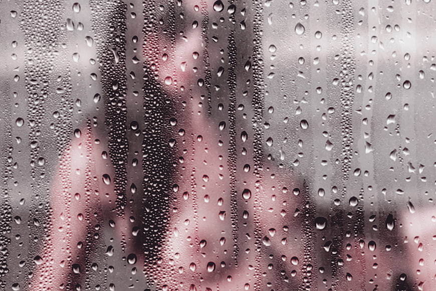 Sensual Silhouette of Woman Behind Rainy Glass