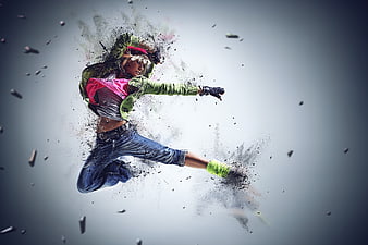 Dynamic female dancer performing high kick with digital particle explosion effect