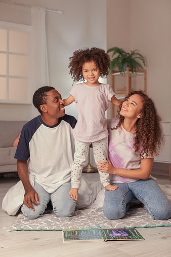 Happy African American Family Playing with Toddler Daughter at Home