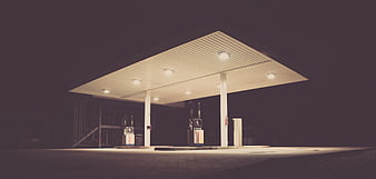 Empty gas station at night with illuminated canopy
