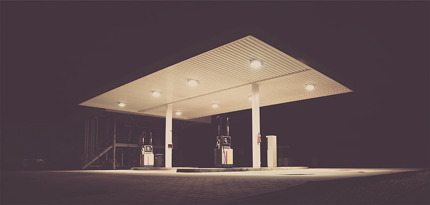 Empty gas station at night with illuminated canopy