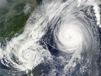 Satellite view of two hurricanes approaching landmass