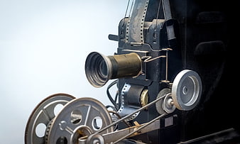 Vintage Film Projector Close-Up with Reels and Film Strip