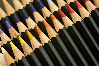 Close-up of colorful colored pencils arranged in a row