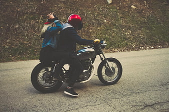Couple Riding Vintage Motorcycle on Scenic Road