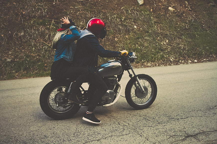 Couple Riding Vintage Motorcycle on Scenic Road