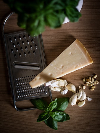 Parmesan Cheese, Garlic, Basil, and Grater on Wooden Table