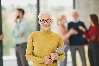 Smiling Senior Businesswoman with Tablet in Office