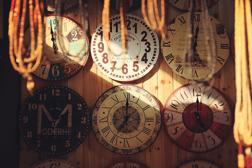 Vintage Wall Clocks on Wooden Background with Beads