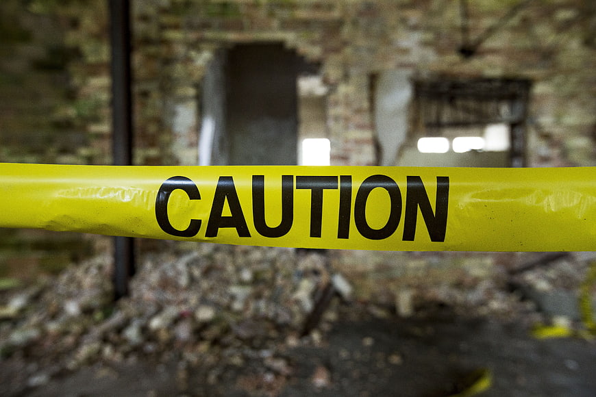 Yellow Caution Tape in Abandoned Building Ruins
