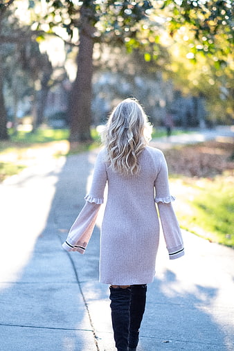 Blonde Woman Walking Away in Park Sunlight