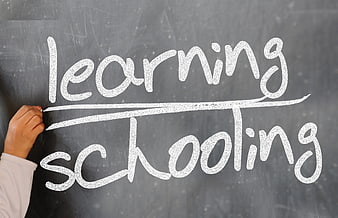 Hand writing learning over schooling on chalkboard