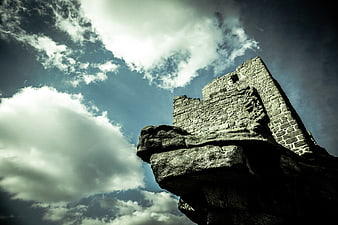 Dramatic Low Angle View of Ancient Stone Castle Ruins on Cliff