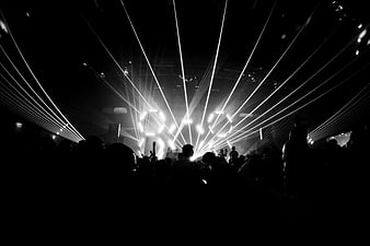 Black and white laser light show at a crowded music concert