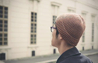 Man in Brown Beanie Looking at Building