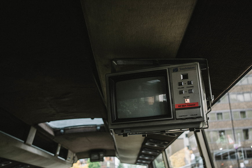 Vintage CRT TV mounted on bus ceiling