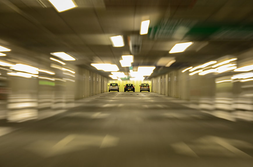 Motion blur effect in underground parking garage with cars