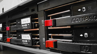 Close-up of HP Compaq server hard drive bays with red handles