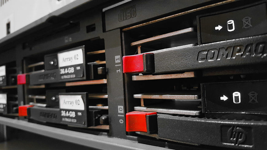 Close-up of HP Compaq server hard drive bays with red handles
