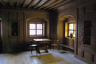 Historic wooden interior with carved paneling and leaded windows