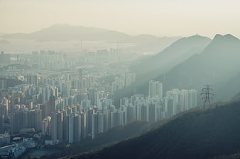 Hazy Aerial View of Hong Kong Cityscape and Mountains
