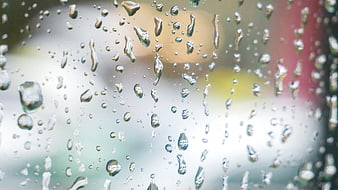 Raindrops on Window Glass with Blurred City Background