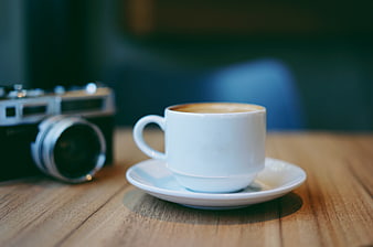 White Coffee Cup and Vintage Camera on Wooden Table