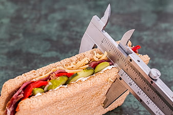 Vernier caliper measuring sandwich thickness for diet concept