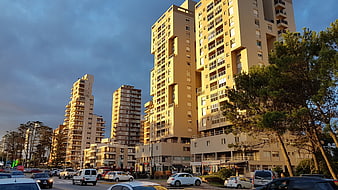 Modern apartment buildings in urban cityscape at sunset