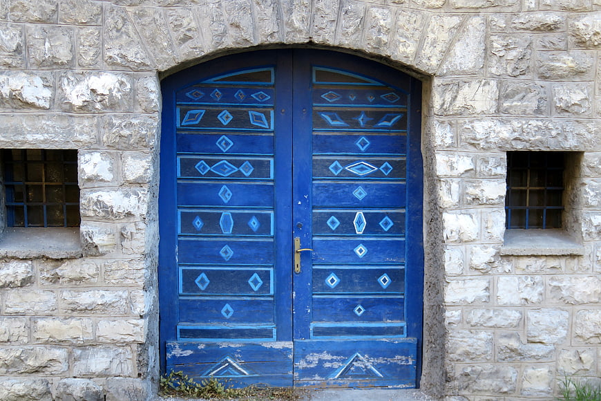 Traditional Blue Wooden Door in Stone Wall