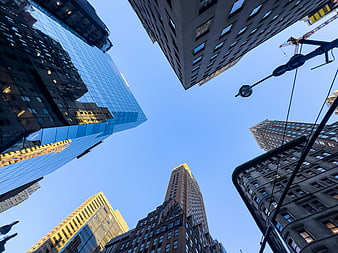 Low angle view of skyscrapers against blue sky