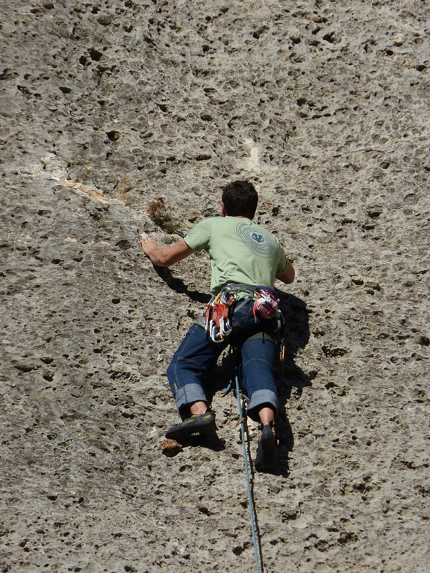 Rock Climber Scaling Steep Limestone Wall