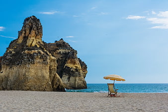 Lone Beach Umbrella and Chair by Coastal Cliffs