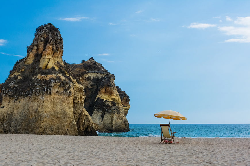 Lone Beach Umbrella and Chair by Coastal Cliffs