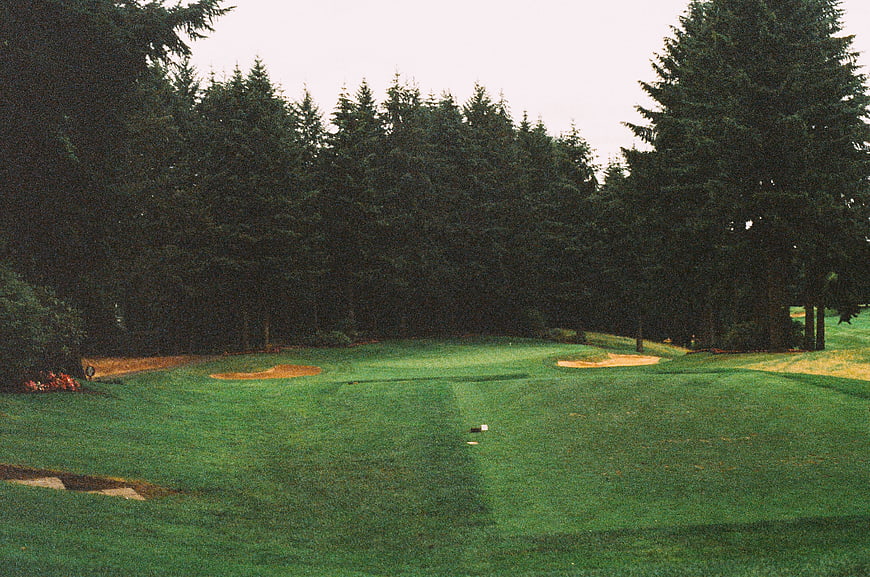 Golf Course Fairway with Sand Traps and Pine Trees