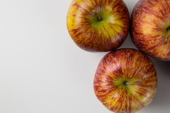 Three Red Streaked Apples On White Background