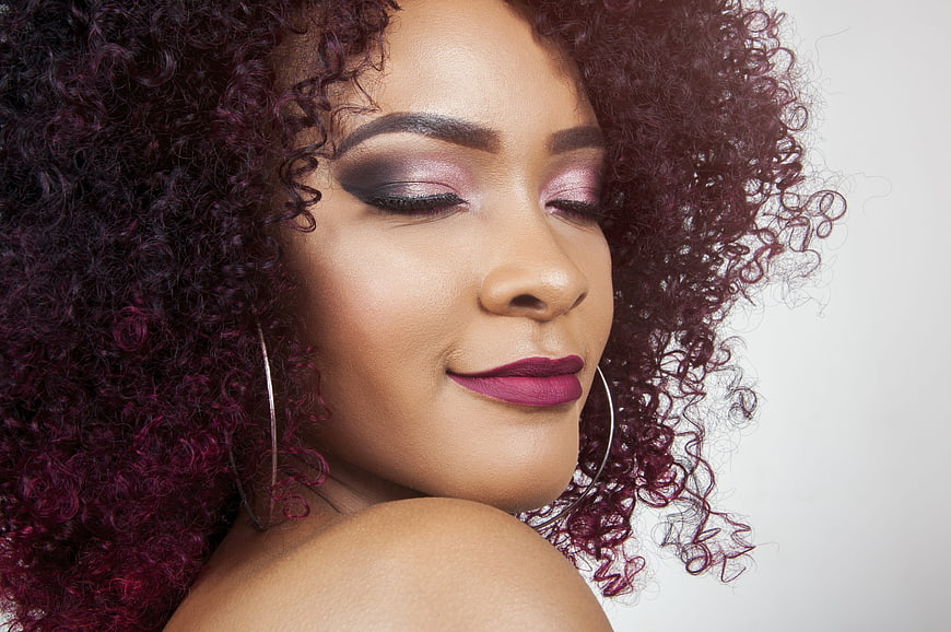 Glamorous Portrait of Woman with Purple Curly Hair and Makeup
