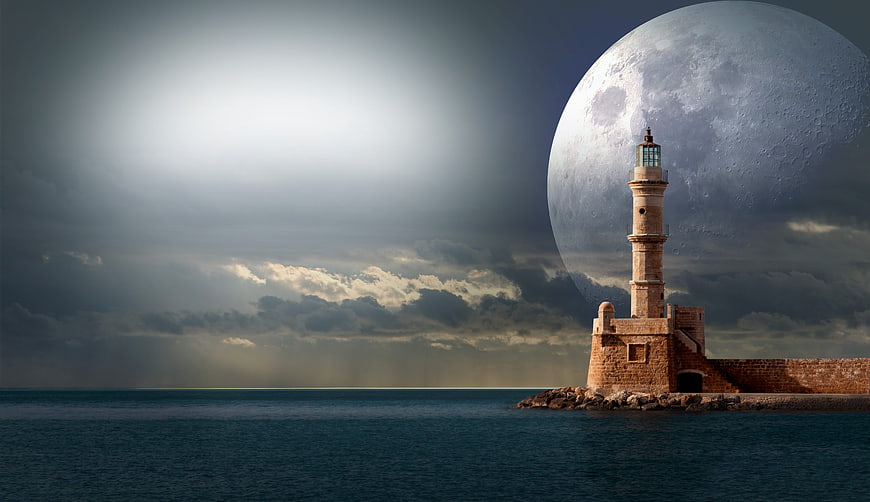 Lighthouse with Giant Moon Over Ocean at Night