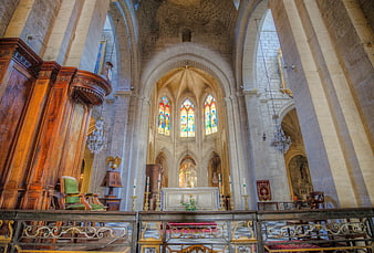 Interior of Gothic Cathedral with Stained Glass Windows and Stone Arches