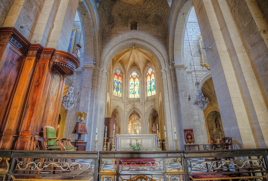Interior of Gothic Cathedral with Stained Glass Windows and Stone Arches