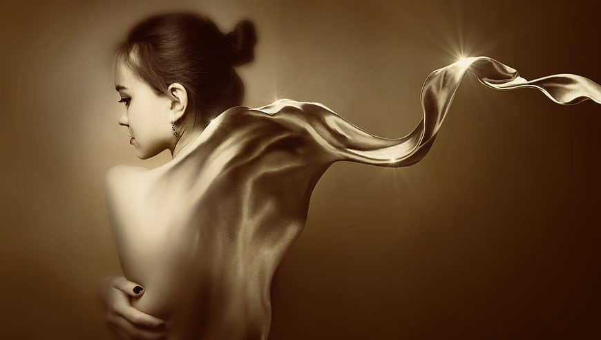 Surreal woman with flowing silk and light on sepia background