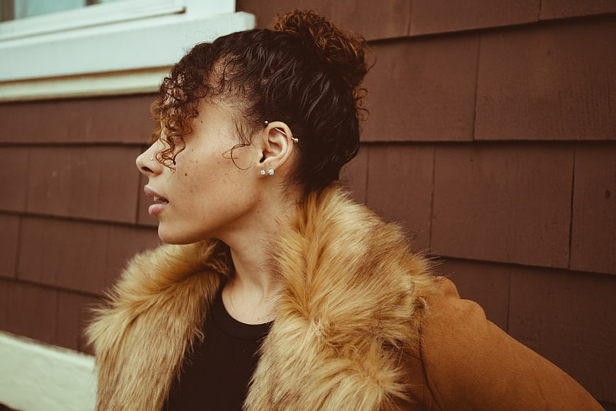 Stylish Woman in Profile Wearing Fur Collar Coat