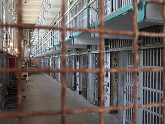 View through rusty bars of an old prison cell block