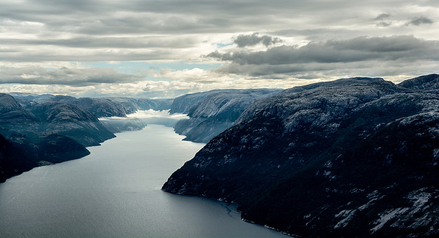 Dramatic Aerial View of Norwegian Fjord with Cloudy Sky