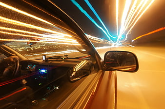 Night driving car interior with light trails