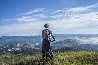 Mountain Biker Overlooking Scenic Valley Landscape