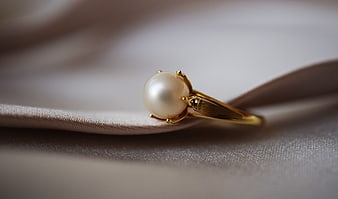 Gold Pearl Ring on Silk Fabric Closeup
