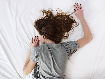 Top View of Woman Sleeping on White Bed Sheets