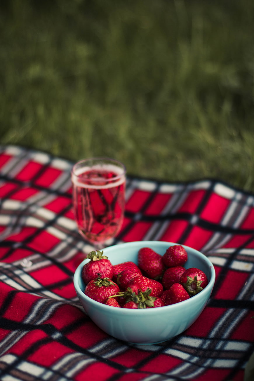 Fresh Strawberries and Red Juice on Plaid Picnic Blanket