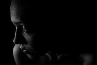 Dramatic Black and White Profile Portrait of Woman in Shadows
